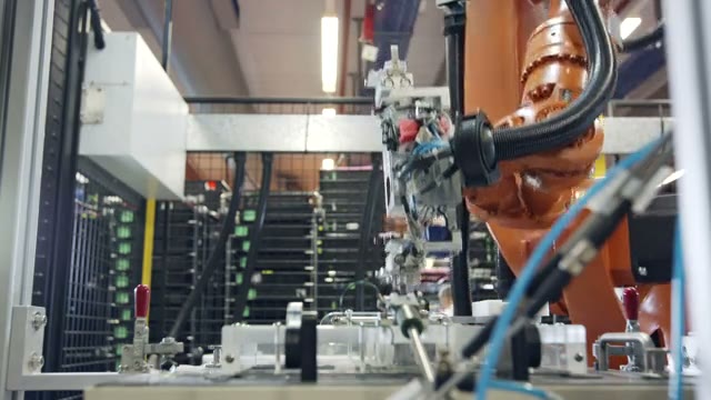 An industrial robot working inside an automated production cell.