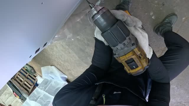 Handheld drilling, recorded from the worker’s point of view.